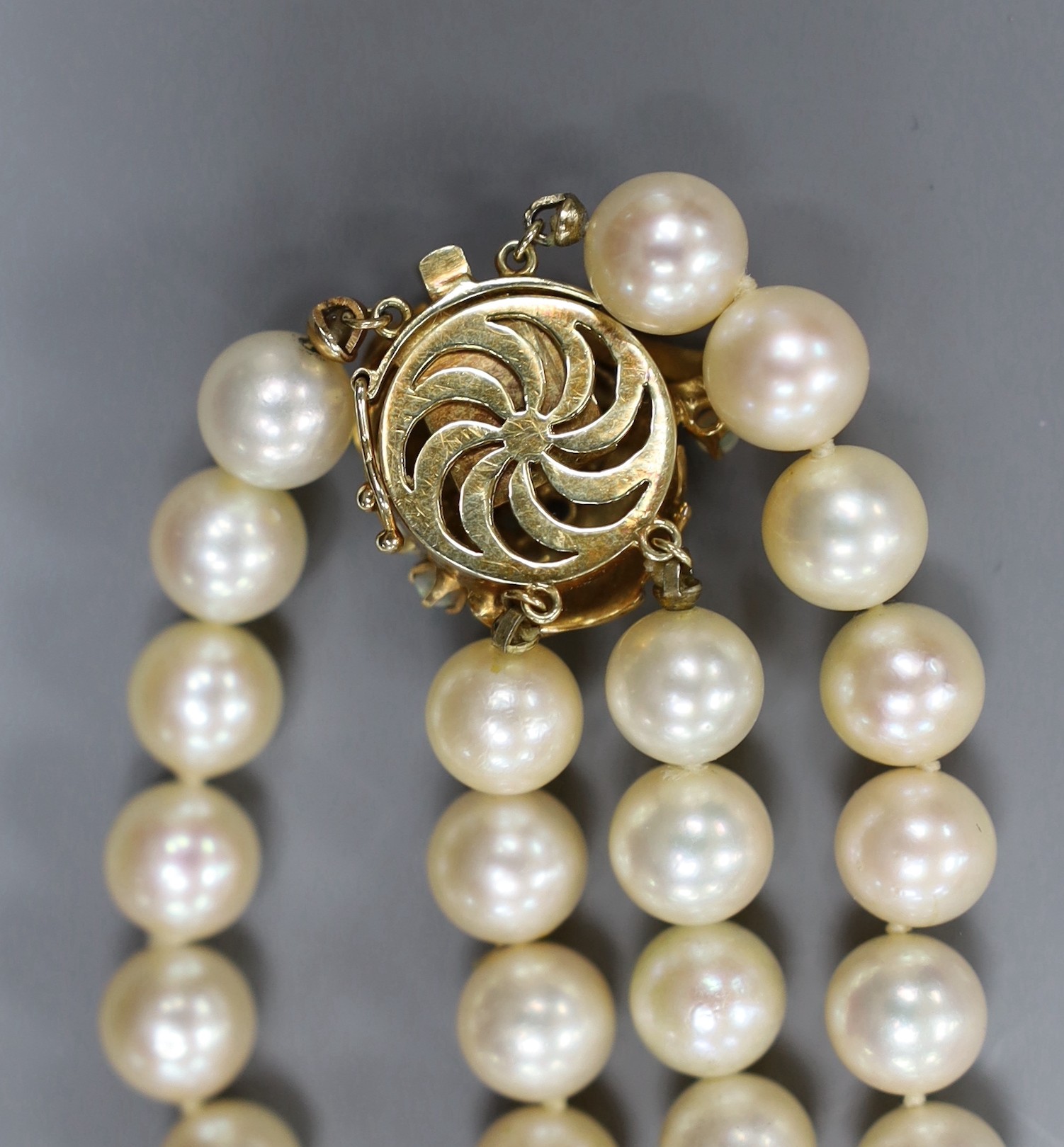A two strand cultured pearl necklace, with white opal set 14ct gold clasp, 35cm